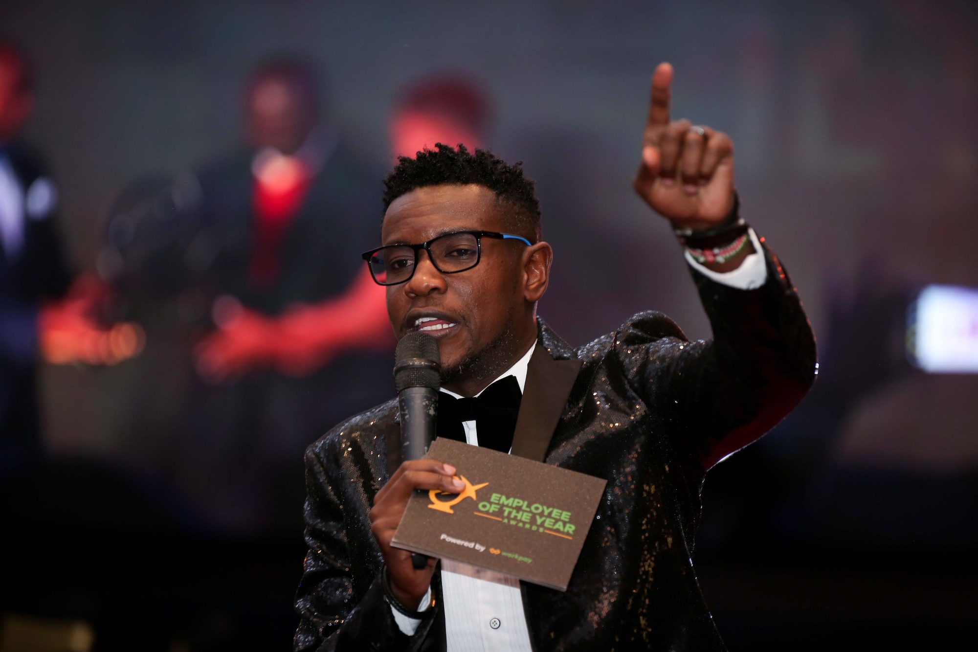 MC on stage at an Employee of the Year awards night
