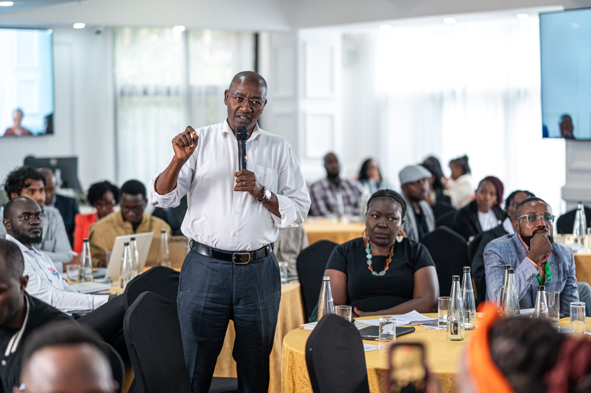 Delegate asking a question at a roundtable forum