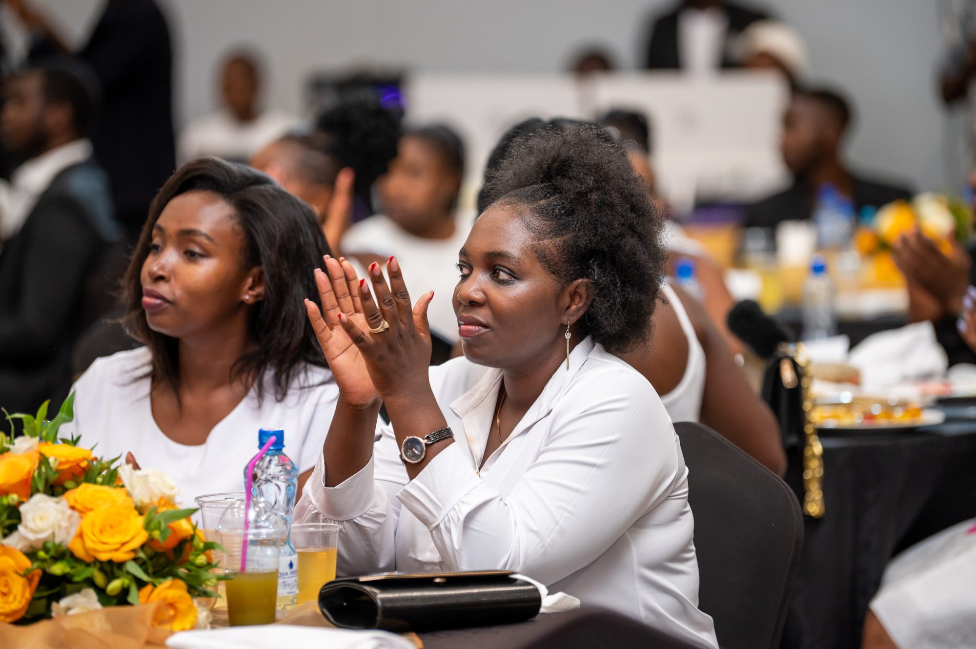Guests applauding at a gala dinner